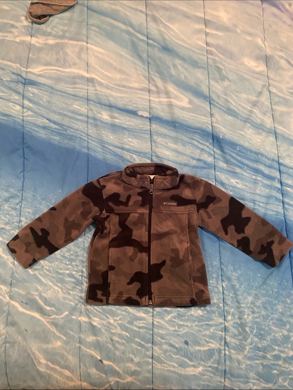 Kids camo jacket on bed